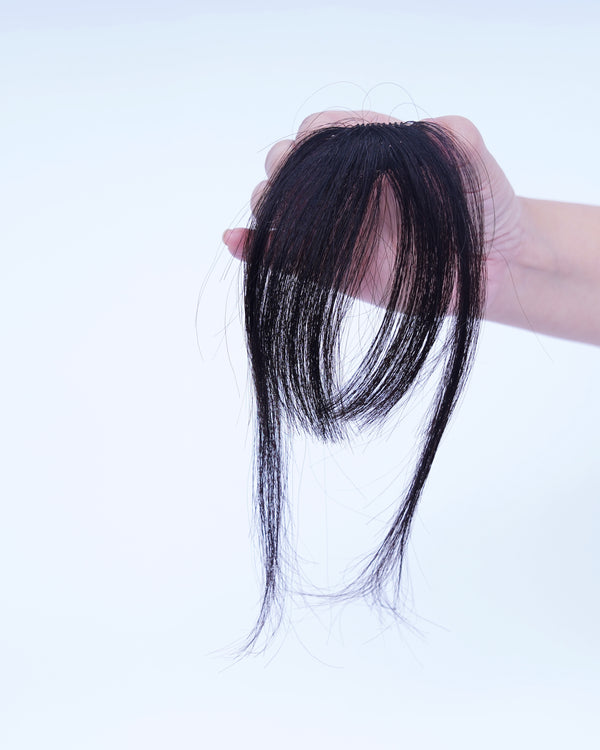 FengFleur wispy air bangs held in hand